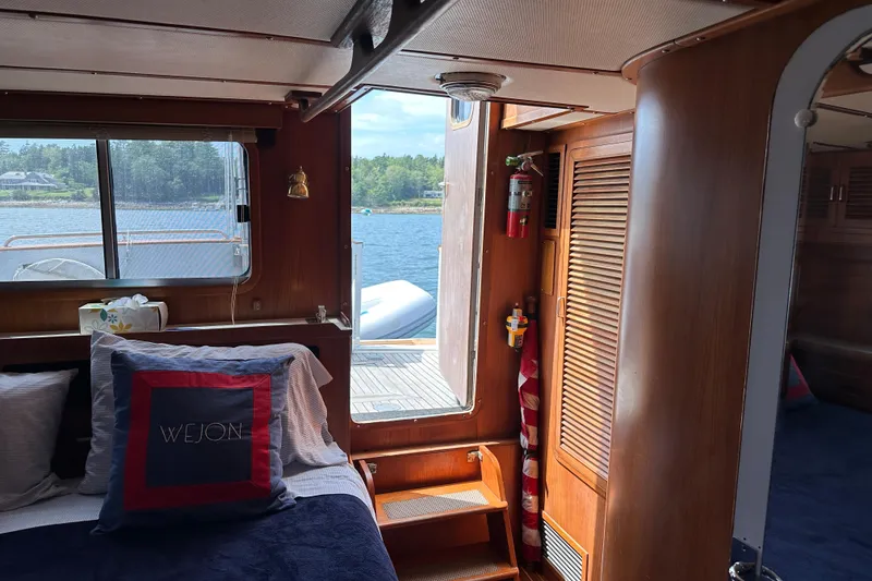 Slide: The Image of Cozy cabin interior of 1987 Albin North Sea Trawler with wooden accents and scenic window view. - 12