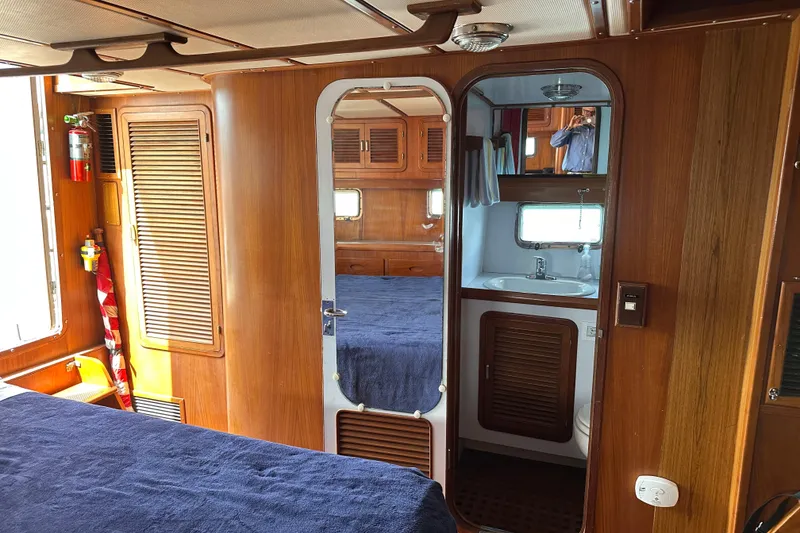 Slide: The Image of Interior of 1987 Albin North Sea Trawler with wood paneling and compact bathroom. - 13
