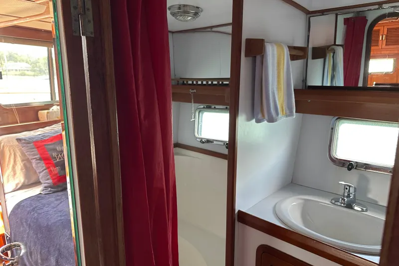 Slide: The Image of 1987 Albin North Sea Trawler interior with cozy bedroom and compact bathroom. - 14