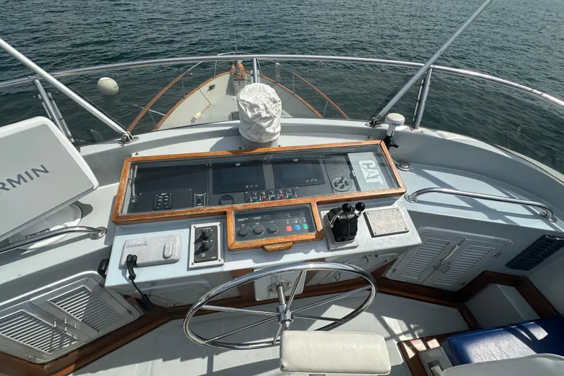 Slide: The Image of 1987 Albin North Sea Trawler helm with navigation equipment and steering wheel on open water. - 17