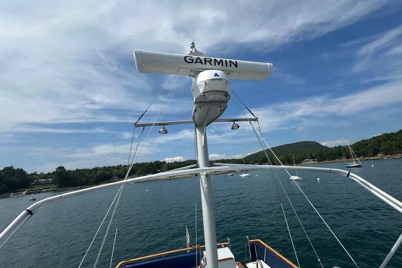 Slide: The Image of 1987 Albin North Sea Trawler with Garmin radar, anchored in scenic coastal waters. - 24