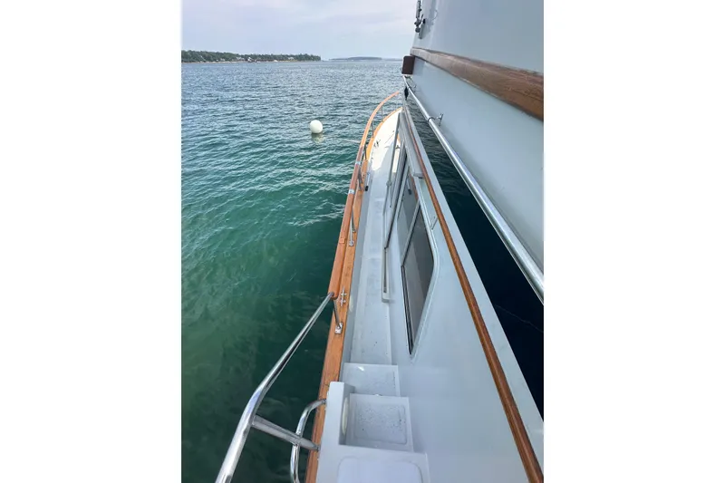 Slide: The Image of 1987 Albin North Sea Trawler on calm water, showcasing deck and railing. - 26