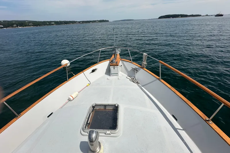 Slide: The Image of 1987 Albin North Sea Trawler cruising on calm waters, scenic coastal view. - 28