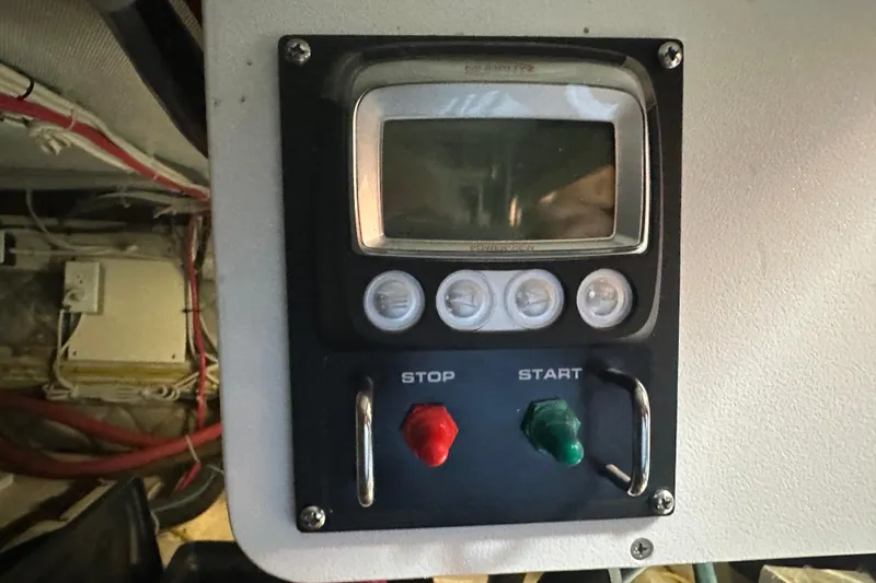 Slide: The Image of Control panel of a 1987 Albin North Sea Trawler with start and stop buttons. - 38