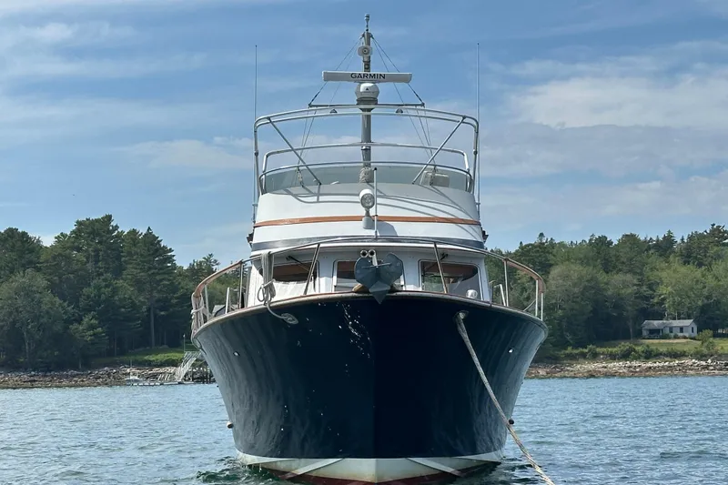 Slide: The Image of 1987 Albin North Sea Trawler anchored in scenic waters with forested shoreline. - 4
