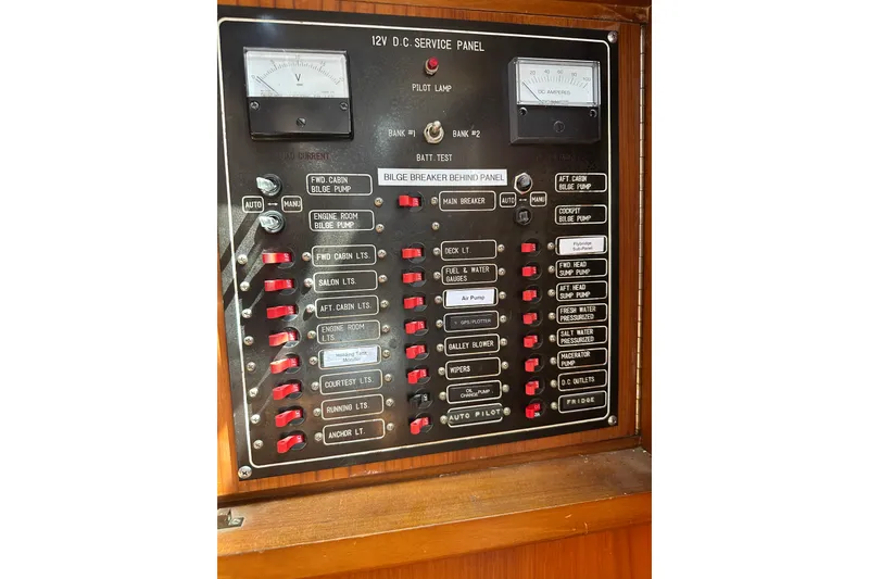Slide: The Image of Control panel of a 1987 Albin North Sea Trawler with various switches and gauges. - 52