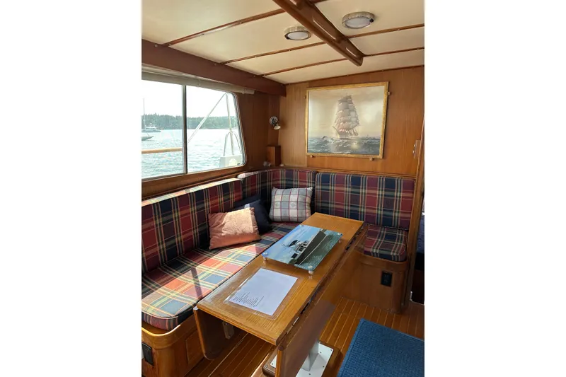 Slide: The Image of Cozy interior of 1987 Albin North Sea Trawler with plaid seating and nautical decor. - 57