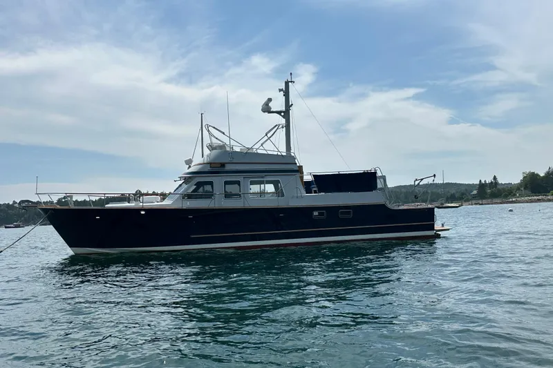 Slide: The Image of 1987 Albin North Sea Trawler on calm water under a partly cloudy sky. - 6