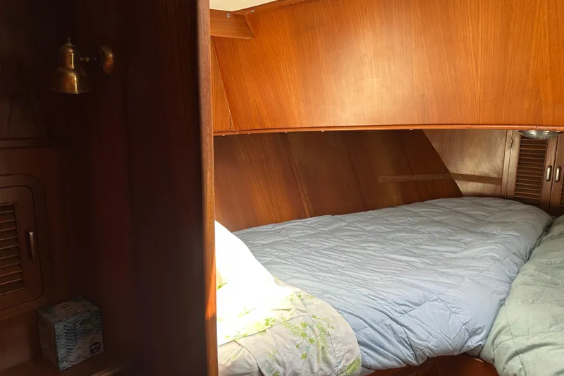 Slide: The Image of Cozy cabin interior of 1987 Albin North Sea Trawler with wooden paneling and bedding. - 69
