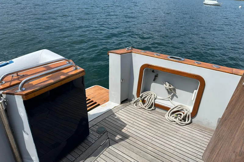 Slide: The Image of 1987 Albin North Sea Trawler deck with ropes, wooden accents, and ocean view. - 8