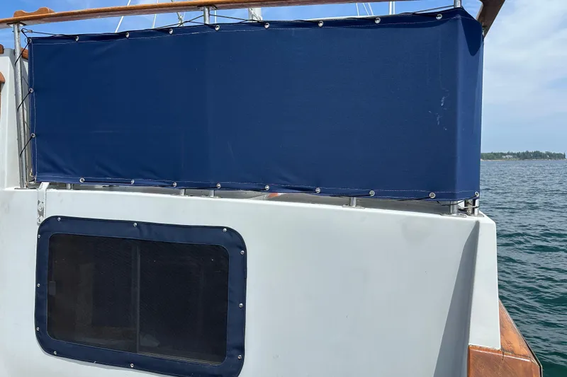 Slide: The Image of 1987 Albin North Sea Trawler with blue canvas cover on deck, ocean in background. - 9