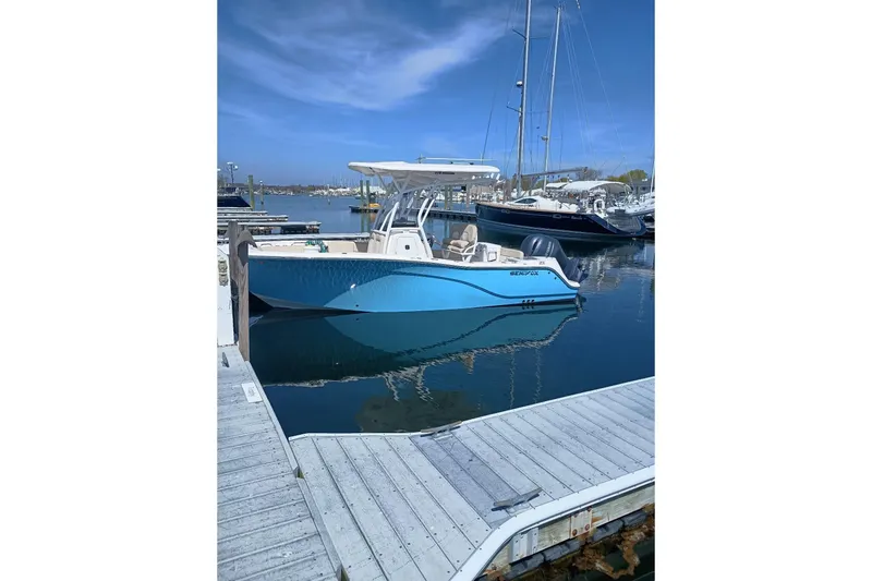 The Image of 2021 Sea Fox 228 Commander boat docked in a marina under clear blue skies. - 0