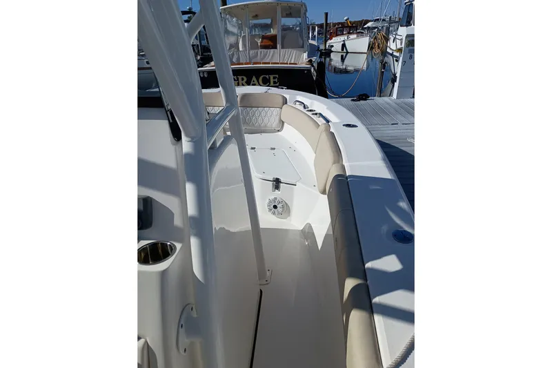 Slide: The Image of 2021 Sea Fox 228 Commander boat interior at dock, featuring seating and cup holders. - 12