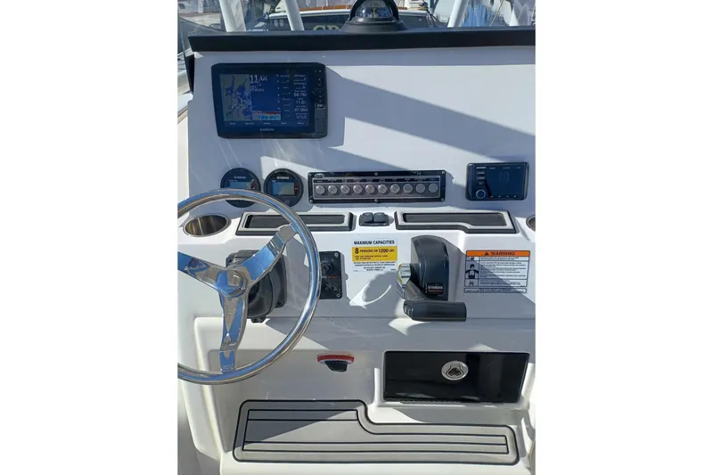 Slide: The Image of 2021 Sea Fox 228 Commander helm with steering wheel, gauges, and navigation display. - 13