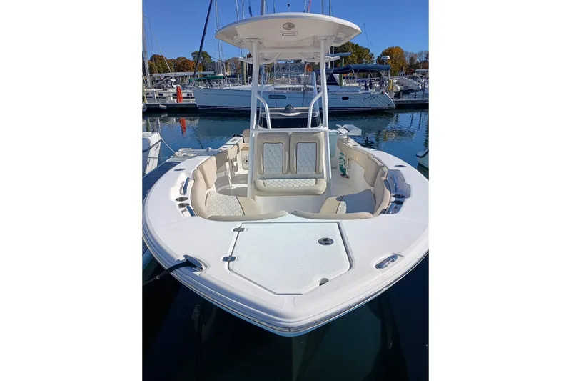 Slide: The Image of 2021 Sea Fox 228 Commander boat docked in a marina, showcasing spacious seating and sleek design. - 3