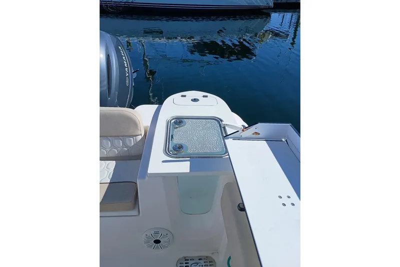 Slide: The Image of 2021 Sea Fox 228 Commander boat with Yamaha engine, docked on calm water. - 4