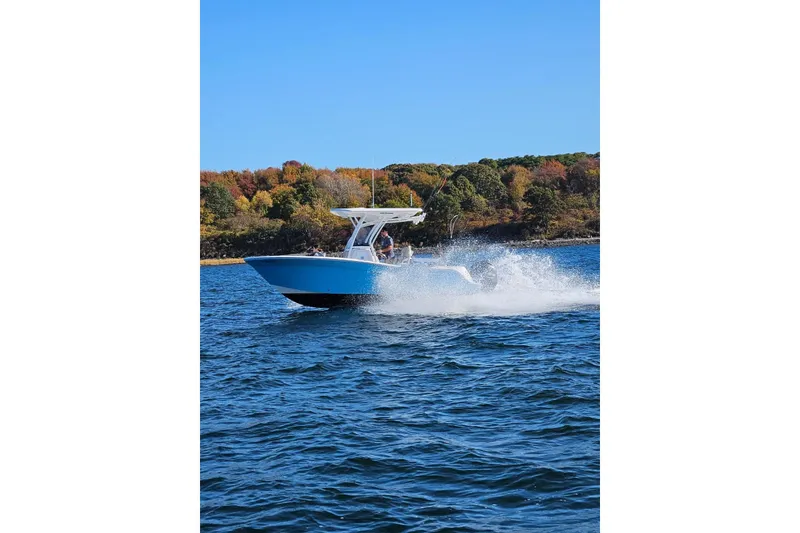 Slide: The Image of 2021 Sea Fox 228 Commander boat cruising on a lake with autumn foliage backdrop. - 8