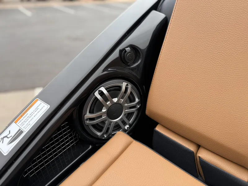 Slide: The Image of 2025 Yamaha Boats 255XD interior speaker and tan seating detail. - 19