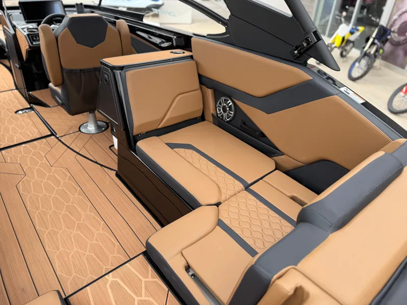 Slide: The Image of 2025 Yamaha Boats 255XD interior with tan and black seating, modern design, and speaker system. - 41