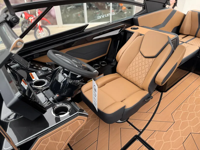 Slide: The Image of 2025 Yamaha Boats 255XD interior with tan seats and modern dashboard design. - 48