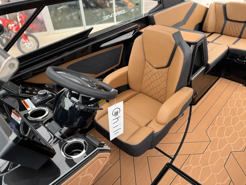 Slide: The Image of 2025 Yamaha Boats 255XD interior with tan seating and modern dashboard design. - 49