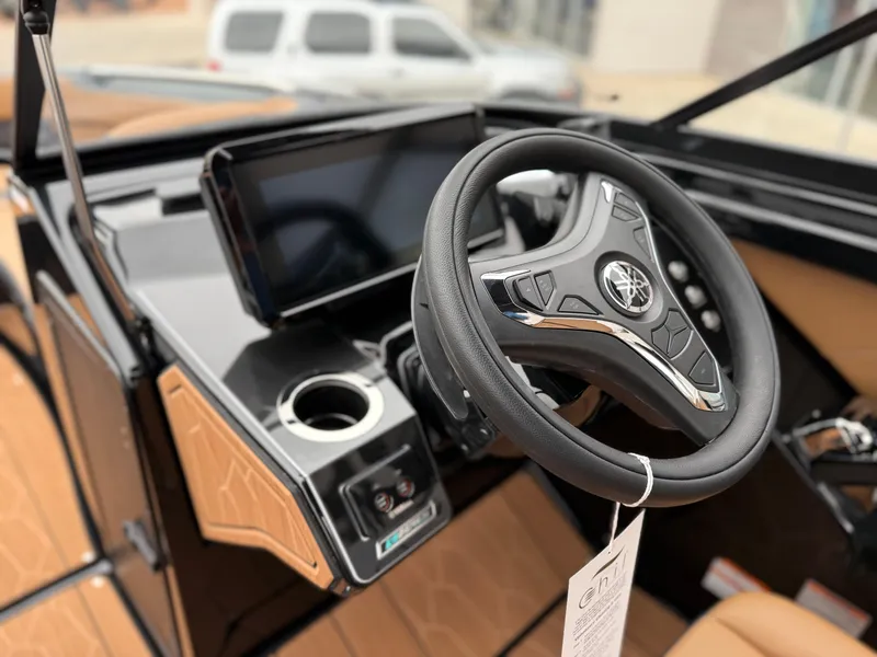 Slide: The Image of 2025 Yamaha Boats 255XD steering wheel and dashboard, featuring modern controls and sleek design. - 50