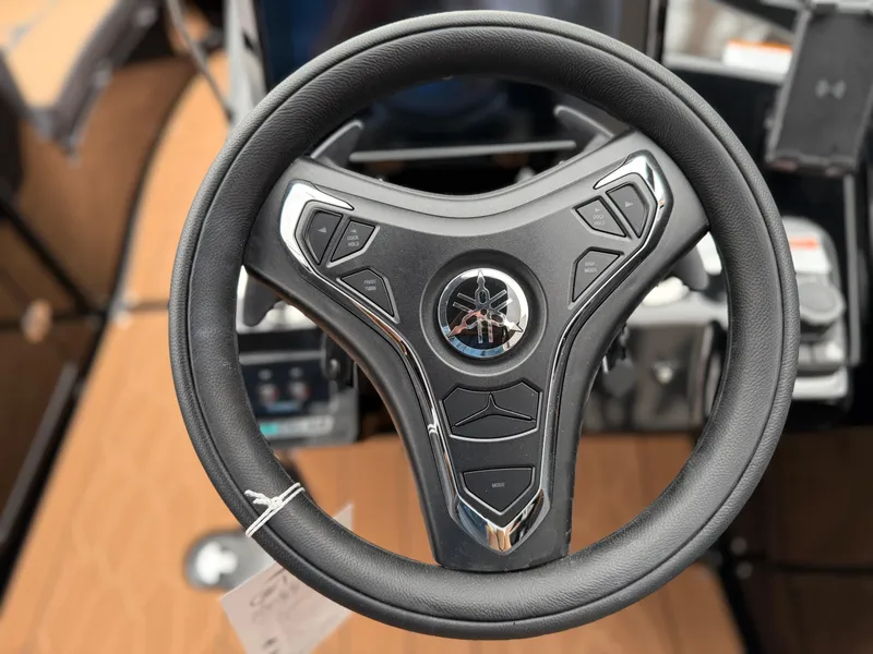 Slide: The Image of Steering wheel of 2025 Yamaha Boats 255XD, featuring modern design and controls. - 51