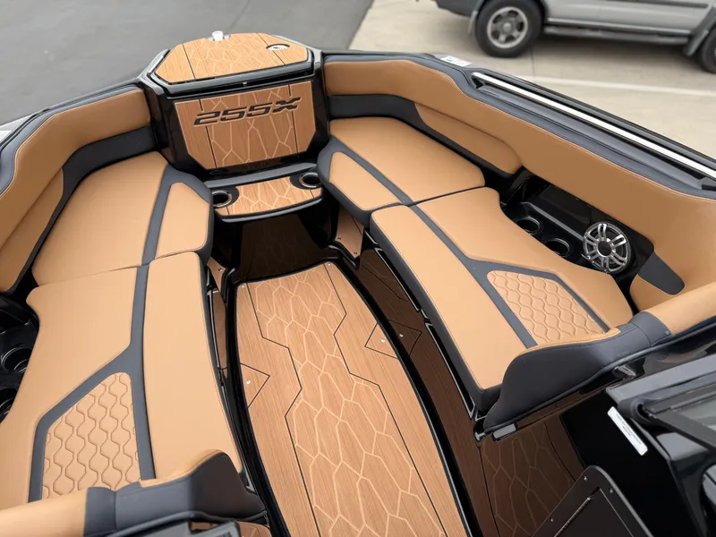 Slide: The Image of 2025 Yamaha Boats 255XD interior with tan and black seating, showcasing luxury design. - 61