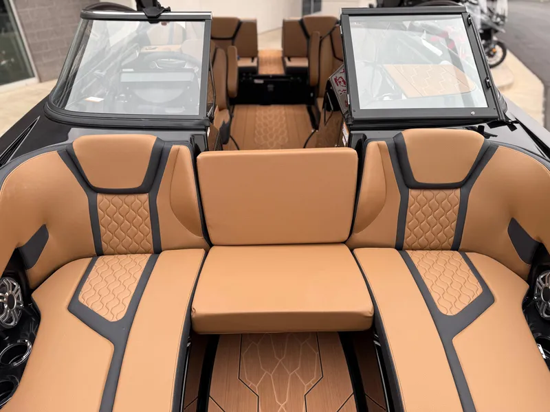Slide: The Image of 2025 Yamaha Boats 255XD interior with tan and black seating, showcasing modern design. - 64
