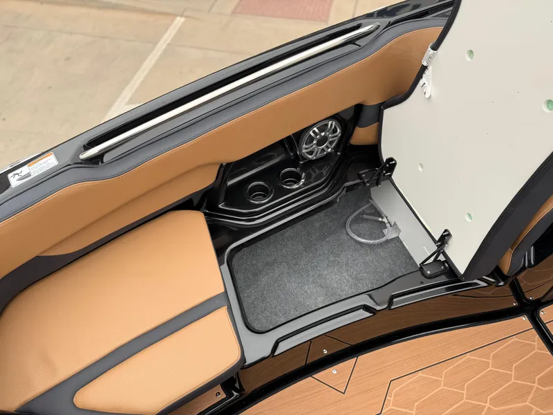 Slide: The Image of 2025 Yamaha Boats 255XD interior with tan seating and built-in speaker system. - 69