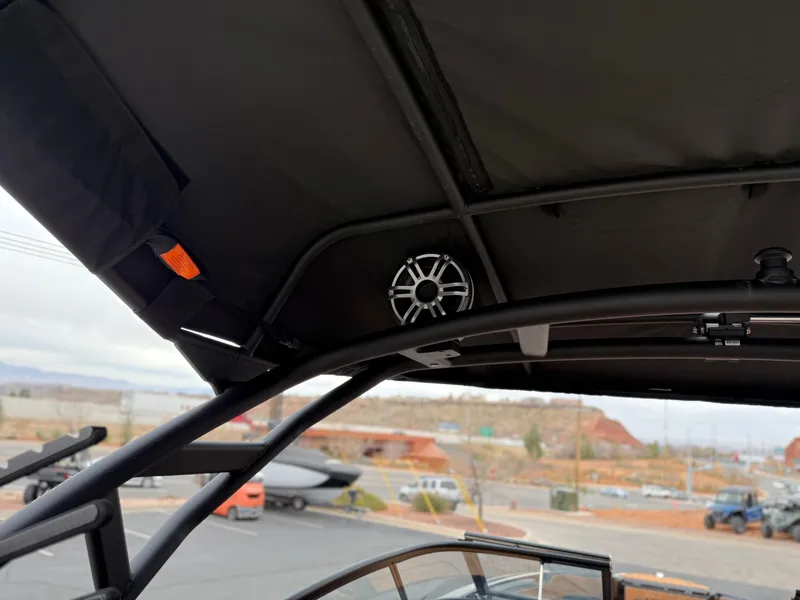 Slide: The Image of 2025 Yamaha Boats 255XD interior view with speaker and canopy details. - 78