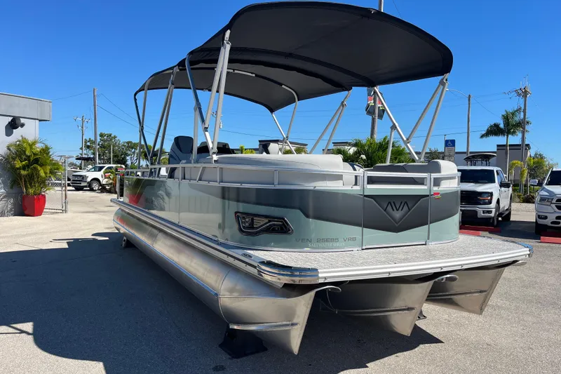 Slide: The Image of 2026 Avalon 2585 Venture 85 VRB Tri Toon boat with canopy, parked outdoors. - 3