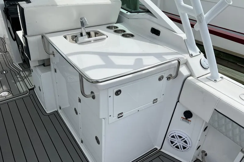 Slide: The Image of 2023 Blackfin 272 DC boat interior with sink and storage compartments. - 12