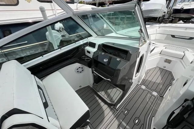 Slide: The Image of 2023 Blackfin 272 DC boat interior with modern dashboard and seating. - 16