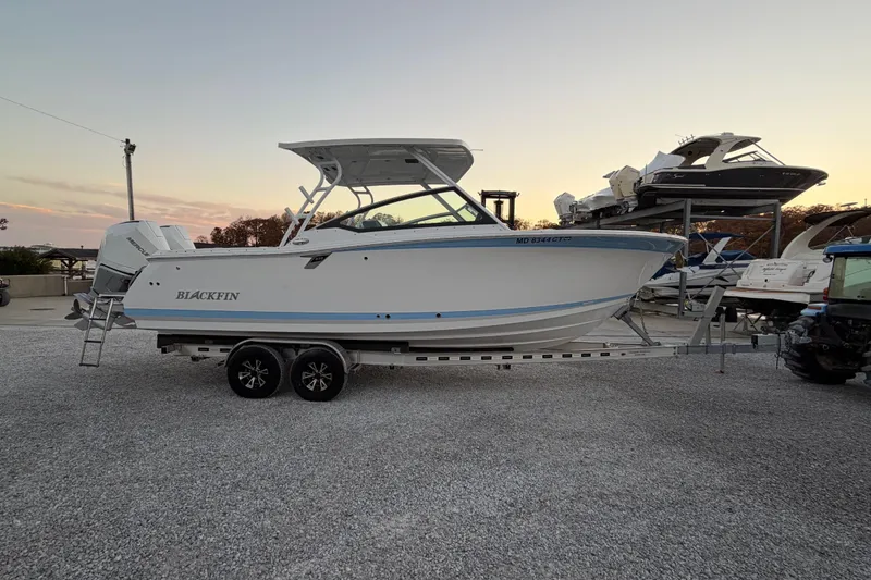 Slide: The Image of 2023 Blackfin 272 DC boat on trailer at sunset, side view. - 25