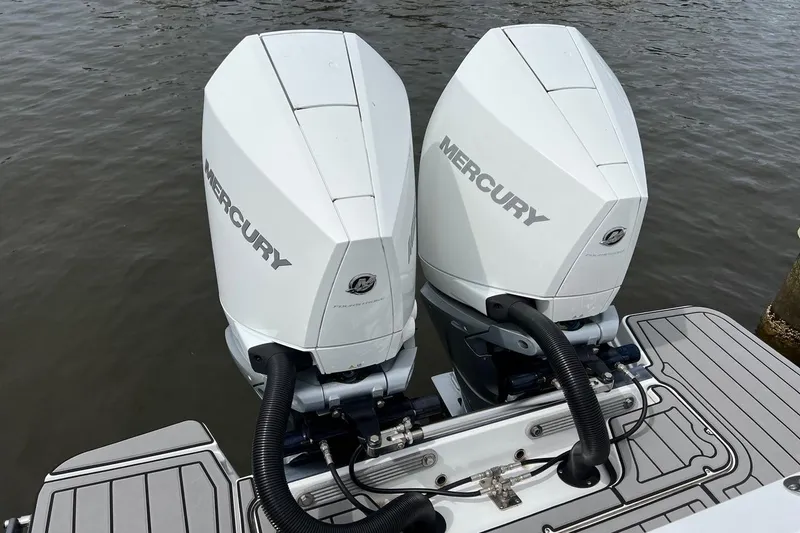 Slide: The Image of Twin Mercury outboard engines on a 2023 Blackfin 272 DC boat, docked on water. - 4
