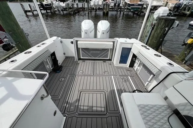 Slide: The Image of 2023 Blackfin 272 DC boat deck with dual engines, docked at marina. - 5