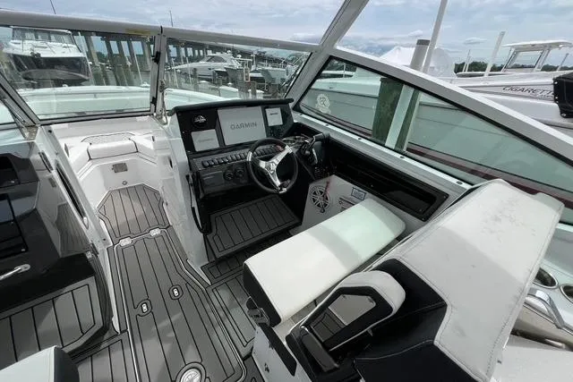 Slide: The Image of 2023 Blackfin 272 DC boat interior with modern dashboard and seating. - 8