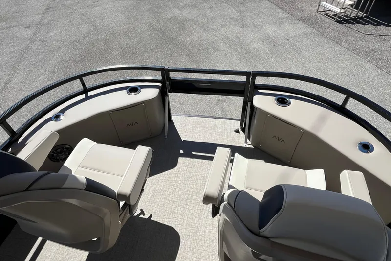 Slide: The Image of 2025 Avalon 2585 Venture boat interior with beige seating and cup holders. - 15