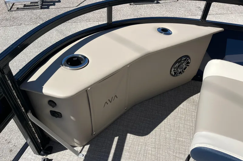 Slide: The Image of 2025 Avalon 2585 Venture boat interior with beige seating and speaker system. - 16