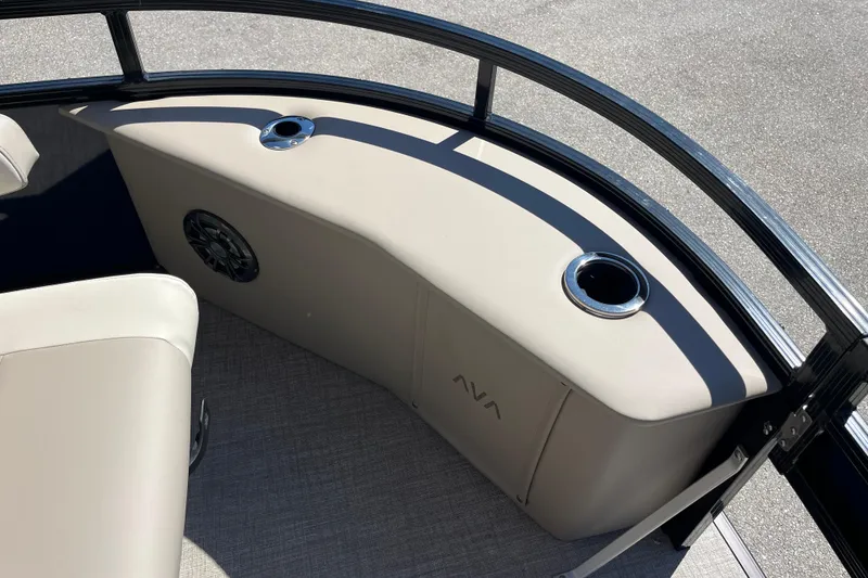 Slide: The Image of 2025 Avalon 2585 Venture boat interior with cup holders and speaker, featuring beige upholstery. - 17