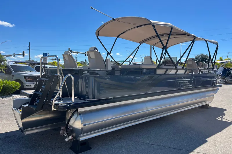 Slide: The Image of 2025 Avalon 2585 Venture 85 Tri Toon boat with center console, parked outdoors. - 5