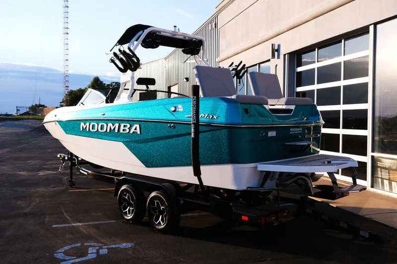 Slide: The Image of 2026 Moomba Max boat on trailer, parked outside a building at sunset. - 10