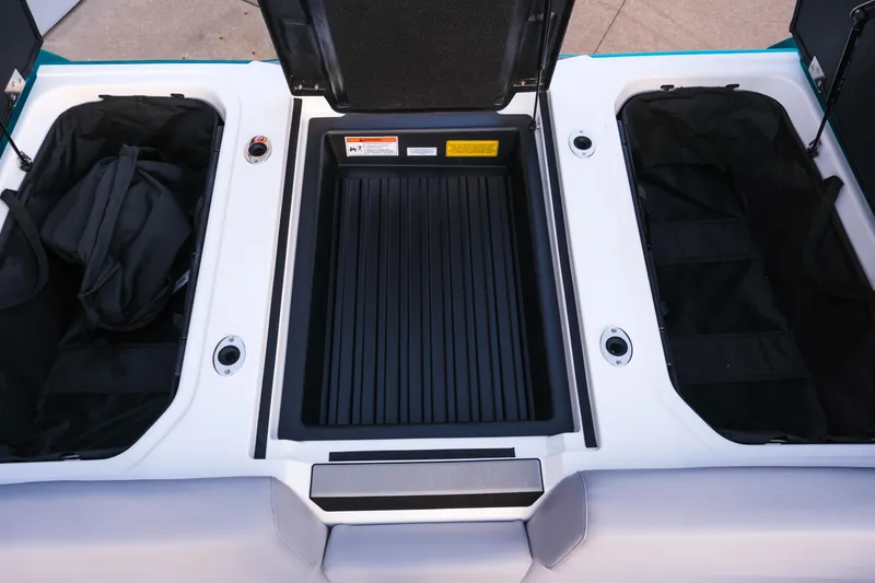 Slide: The Image of 2026 Moomba Max boat storage compartments with open lids and visible interior. - 25