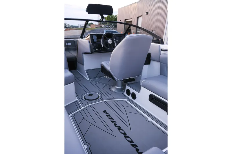 Slide: The Image of 2026 Moomba Max boat interior with sleek gray seating and modern dashboard. - 27