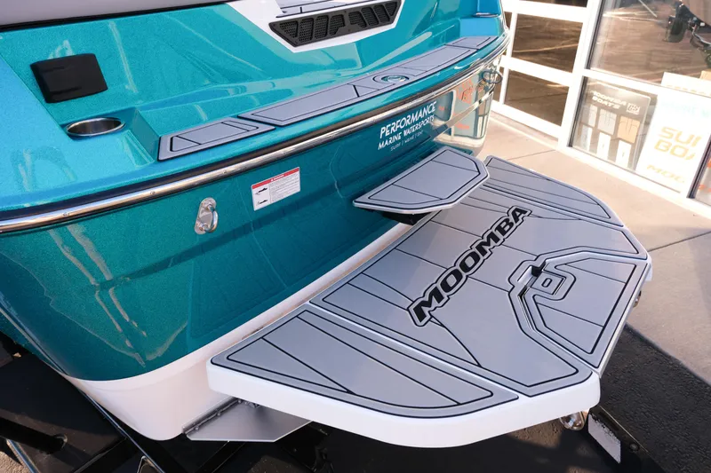 Slide: The Image of 2026 Moomba Max boat with teal exterior and branded swim platform. - 5