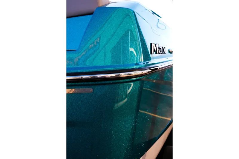 Slide: The Image of 2026 Moomba Max boat, close-up of teal exterior with chrome detailing. - 8