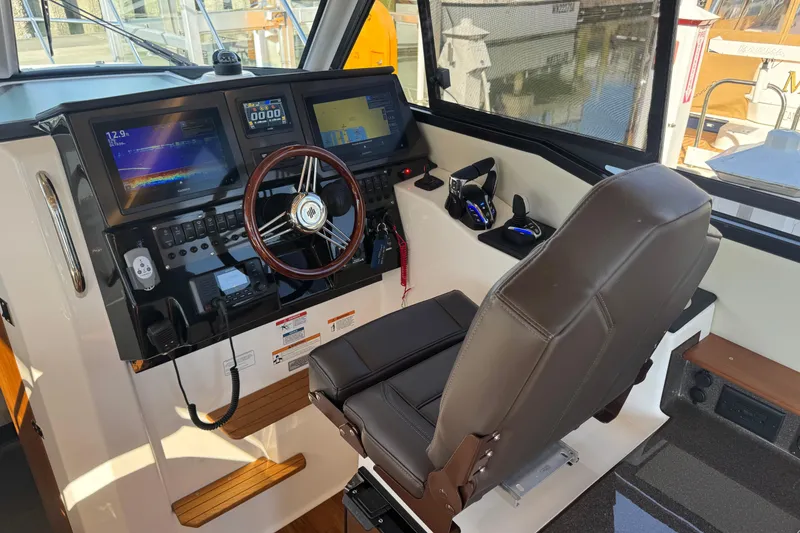 Slide: The Image of Interior helm of 2026 Cutwater C-288 CB boat with advanced navigation controls. - 10