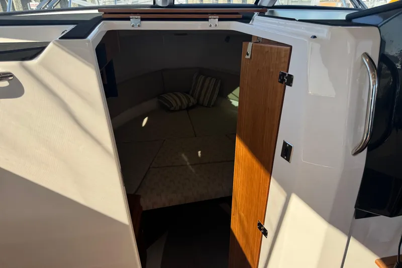 Slide: The Image of 2026 Cutwater C-288 CB cabin interior with open door and cushions. - 13