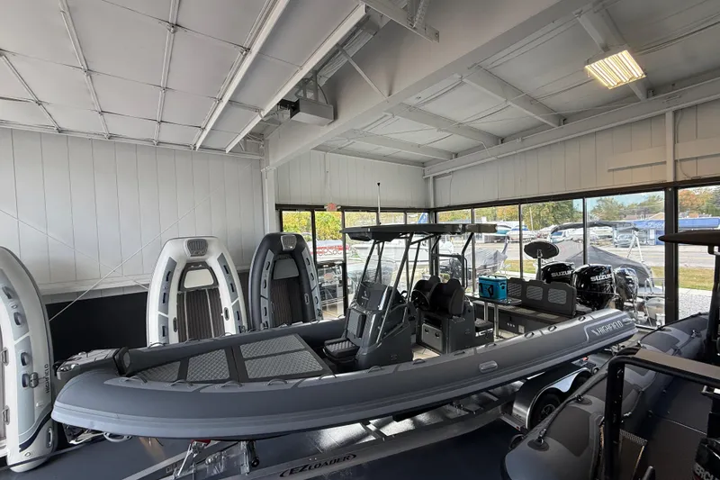 The Image of 2025 Highfield Sport 800 boat displayed in a showroom with modern interior. - 0